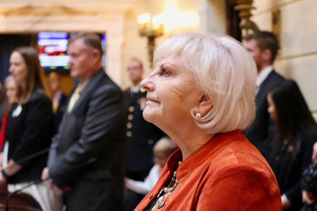 Sen. Karen Mayne looks on as the citation is read.