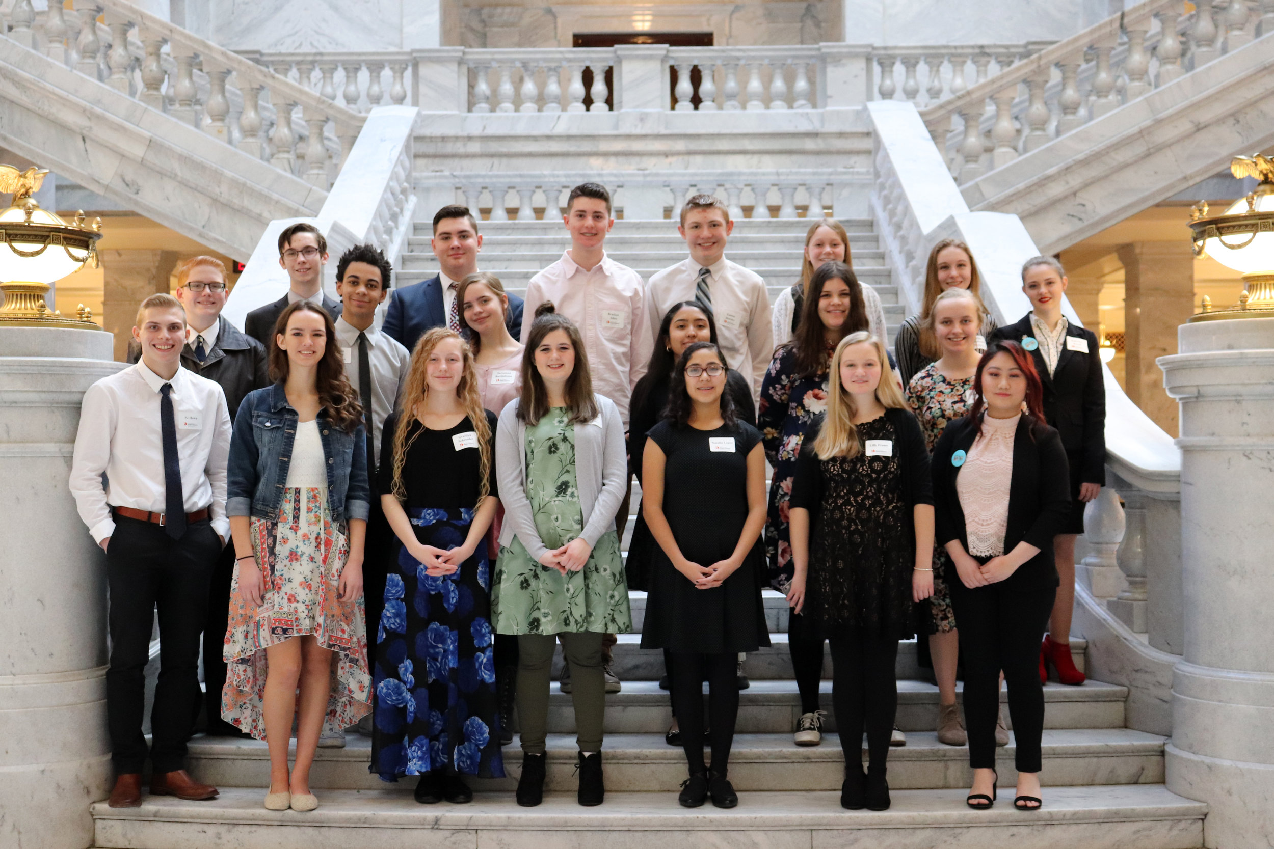 On the interior steps of the Capitol, students gather for a group photo.